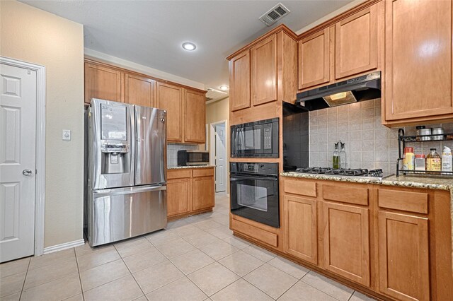 kitchen featuring black appliances, light tile patterned flooring, light stone countertops, and tasteful backsplash