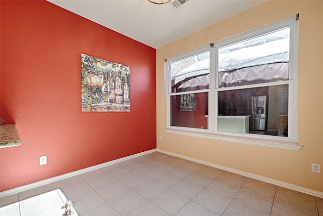 unfurnished room with tile patterned floors