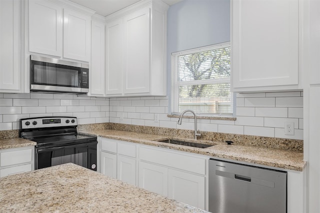 3005 Blackjack Ln, Granbury, TX 76048 - kitchen featuring stainless steel appliances, a sink, white cabinetry, backsplash, and light stone countertops