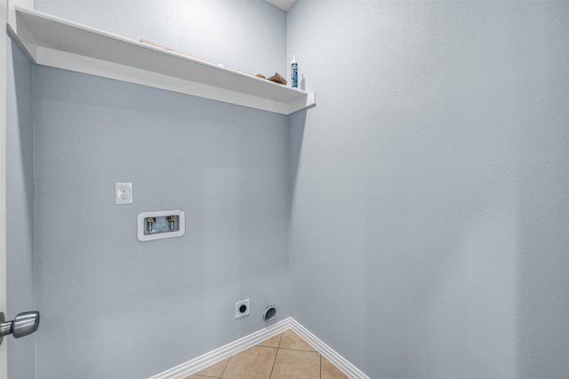 clothes washing area featuring hookup for an electric dryer, hookup for a washing machine, and light tile patterned floors