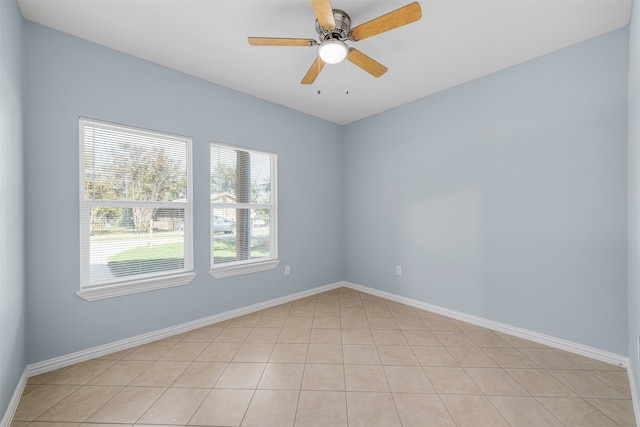 spare room featuring ceiling fan and light tile patterned flooring