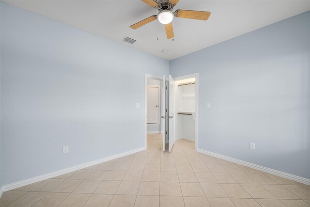 spare room featuring ceiling fan and light tile patterned floors