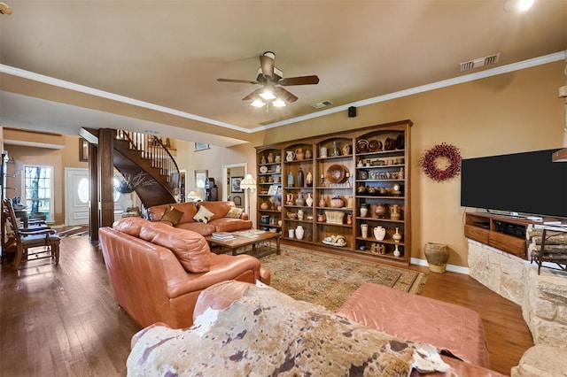 living room with ornamental molding, ceiling fan, and dark wood-type flooring