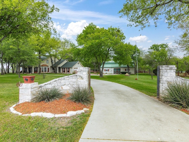 view of front of house with concrete driveway and a front yard