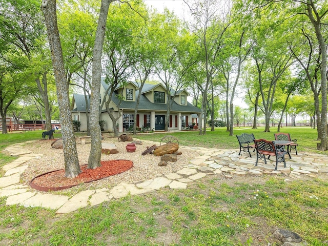 view of yard featuring a patio area, fence, and an outdoor fire pit