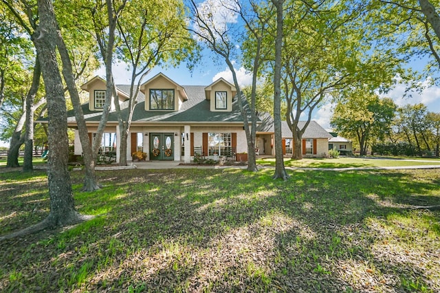 view of front of house with a porch, a front yard, and french doors