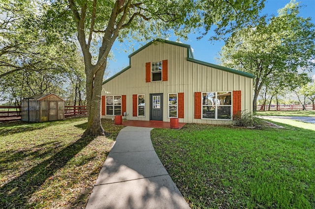 view of front of house featuring an outbuilding and a front lawn