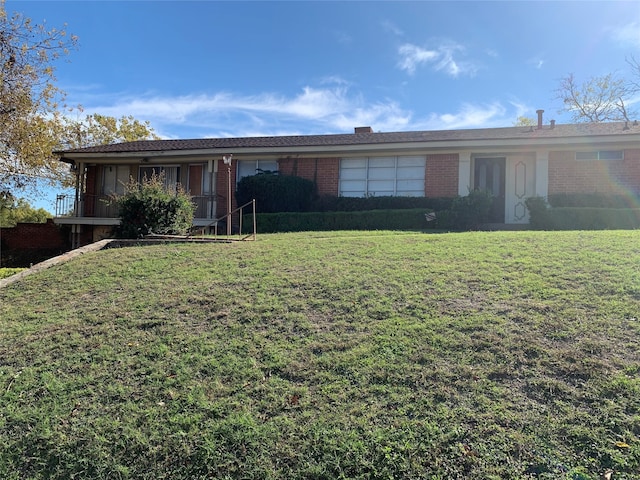 single story home with brick siding and a front lawn