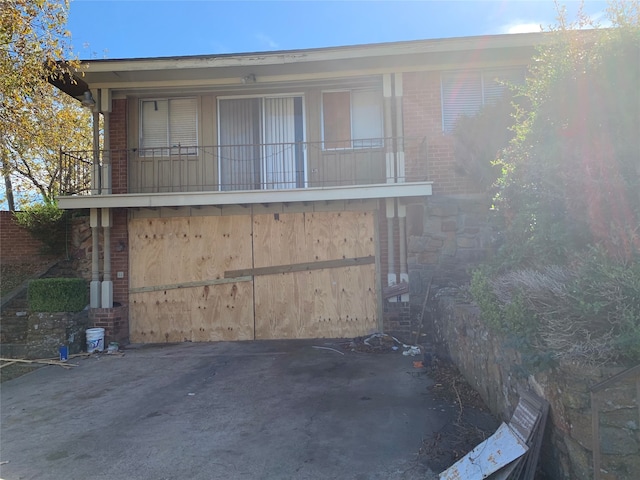 view of home's exterior featuring a balcony and a garage