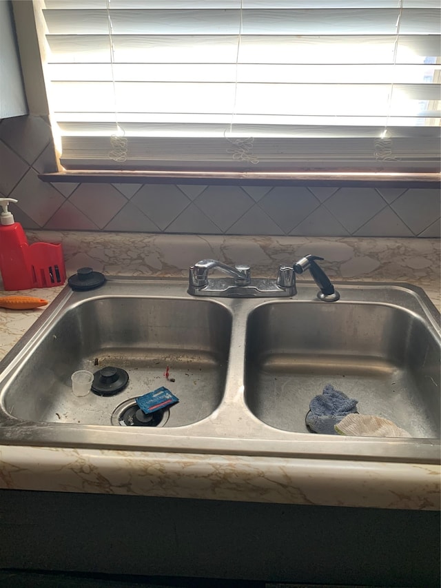 details featuring backsplash and sink