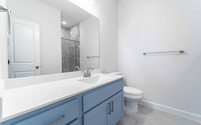 full bath featuring tile patterned flooring, toilet, vanity, baseboards, and a stall shower