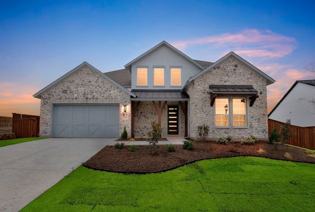 view of front facade with a yard and a garage