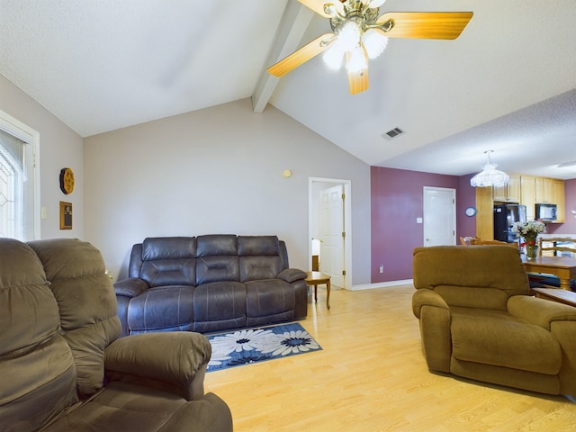 living room featuring lofted ceiling with beams, light hardwood / wood-style floors, and ceiling fan