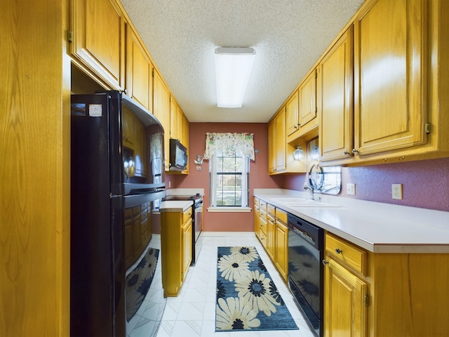 kitchen with black appliances, sink, and a textured ceiling