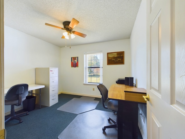 carpeted office space featuring ceiling fan and a textured ceiling