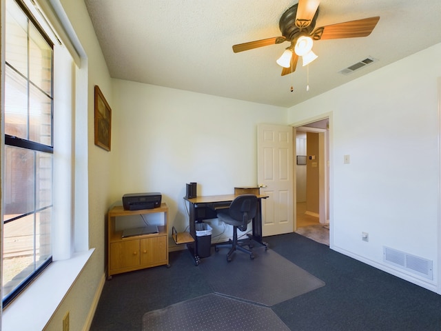 home office featuring ceiling fan and a textured ceiling