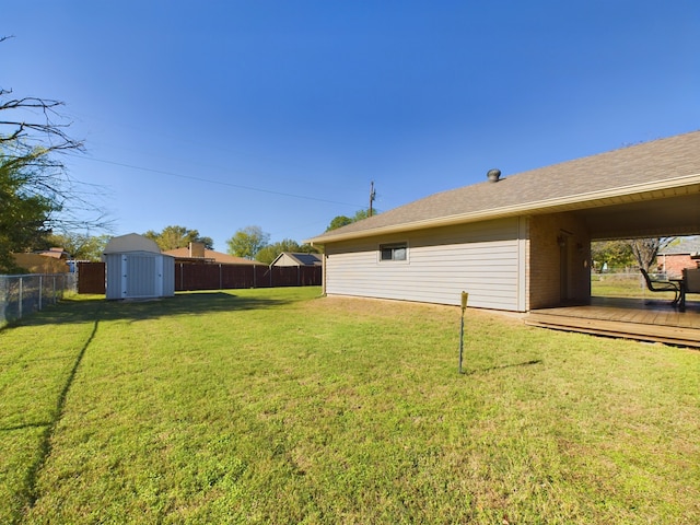 view of yard with a storage shed and a deck