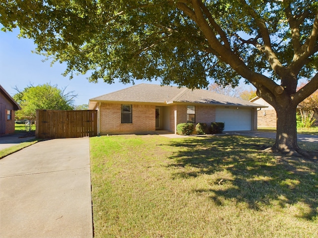 single story home featuring a garage and a front lawn