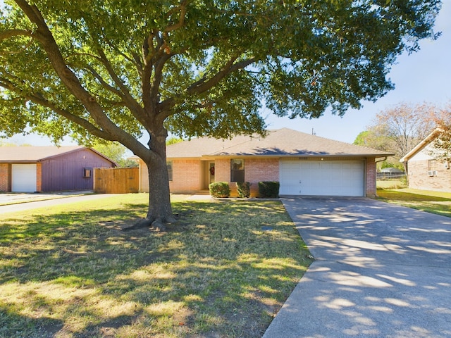 ranch-style house with a garage and a front lawn