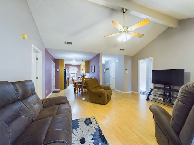 living room featuring vaulted ceiling with beams, light hardwood / wood-style flooring, and ceiling fan with notable chandelier