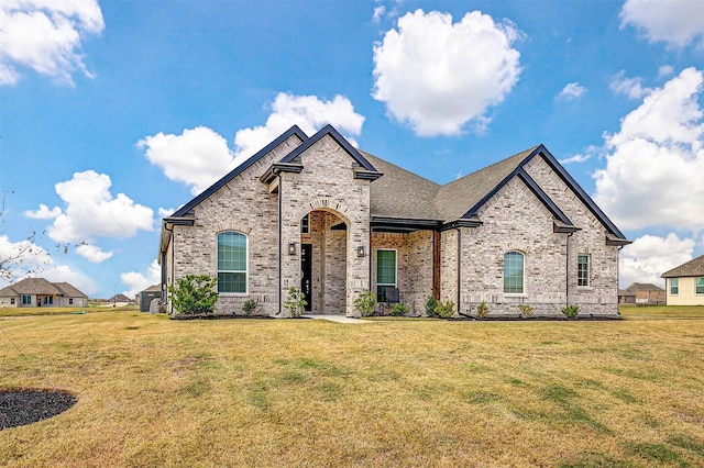 french provincial home featuring a front lawn