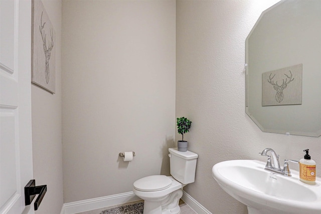 bathroom with toilet and sink