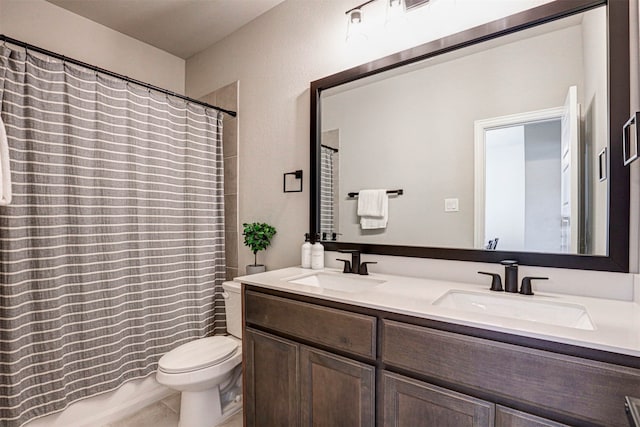 bathroom with tile patterned floors, vanity, and toilet