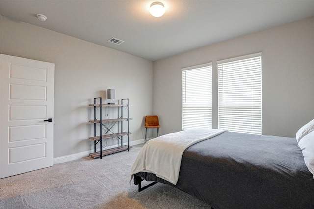 bedroom featuring light carpet