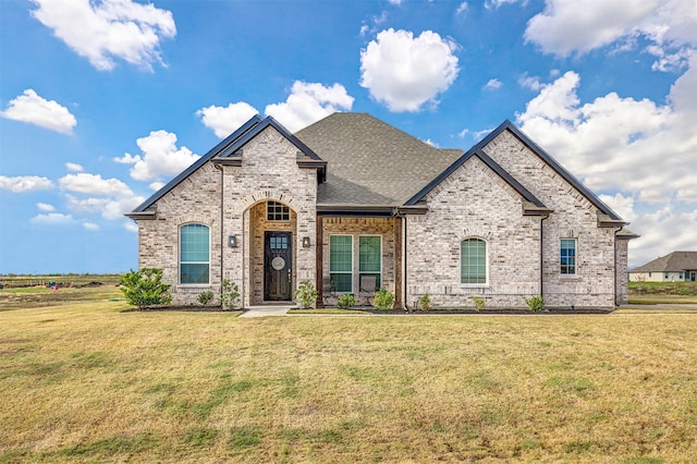 french provincial home featuring a front yard