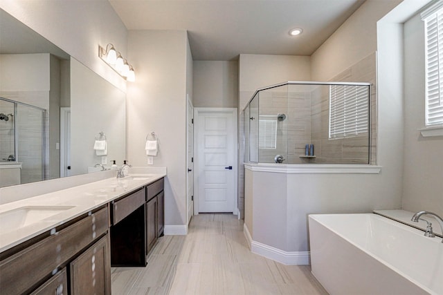 bathroom featuring plus walk in shower and vanity