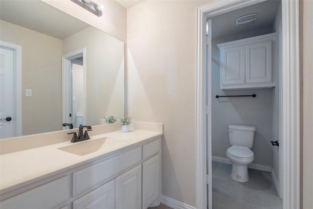 bathroom with tile patterned floors, vanity, and toilet