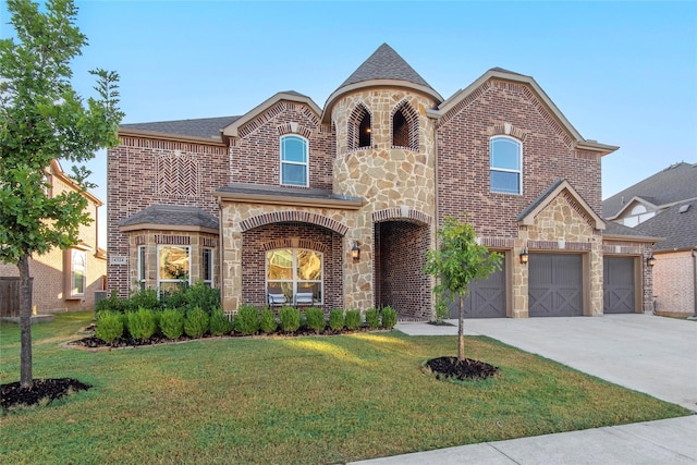 french country style house featuring a garage and a front lawn