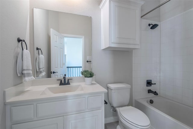 full bathroom featuring vanity, tiled shower / bath combo, and toilet