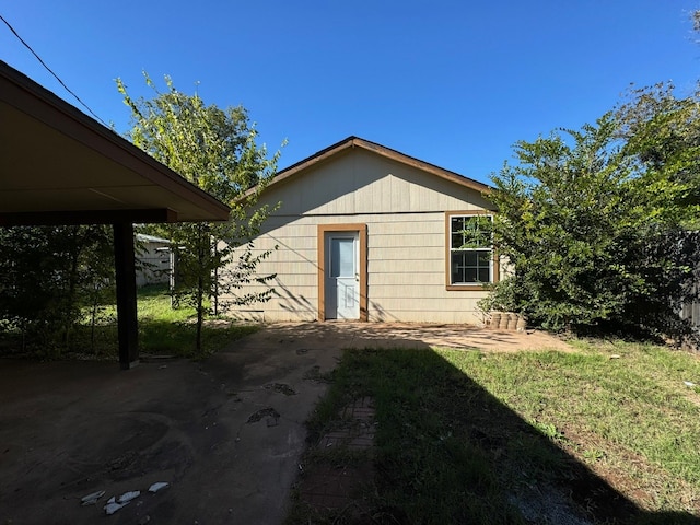 rear view of property featuring a yard and a patio