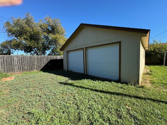 garage featuring a lawn