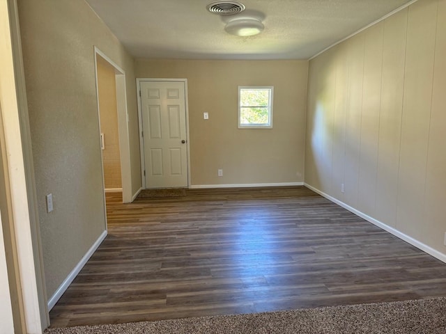 unfurnished room with dark wood-type flooring