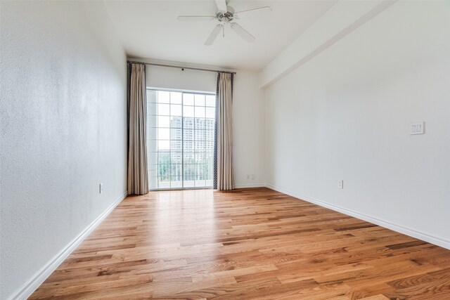 empty room featuring ceiling fan and light hardwood / wood-style flooring