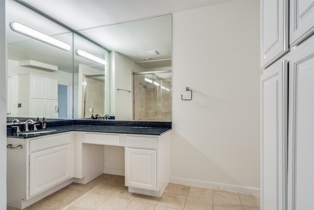 bathroom with tile patterned flooring, vanity, and an enclosed shower