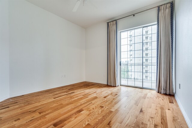 spare room featuring ceiling fan and light hardwood / wood-style flooring