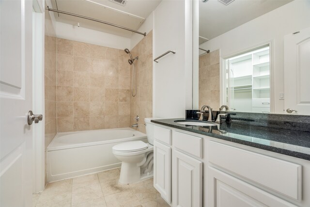 full bathroom with tile patterned floors, vanity, toilet, and tiled shower / bath