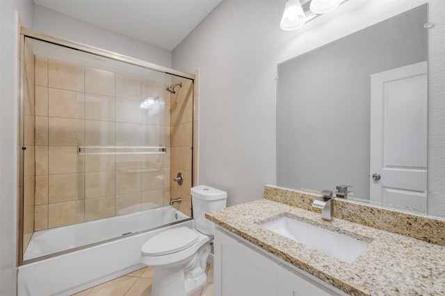 full bathroom featuring tile patterned flooring, vanity, enclosed tub / shower combo, and toilet