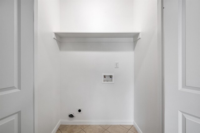 clothes washing area featuring hookup for an electric dryer, washer hookup, and light tile patterned floors