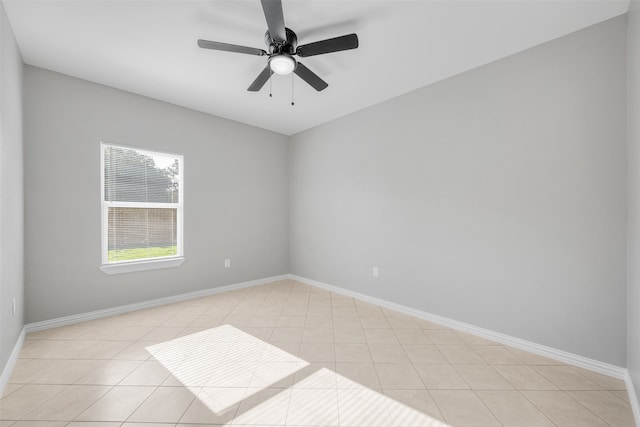 tiled spare room with ceiling fan