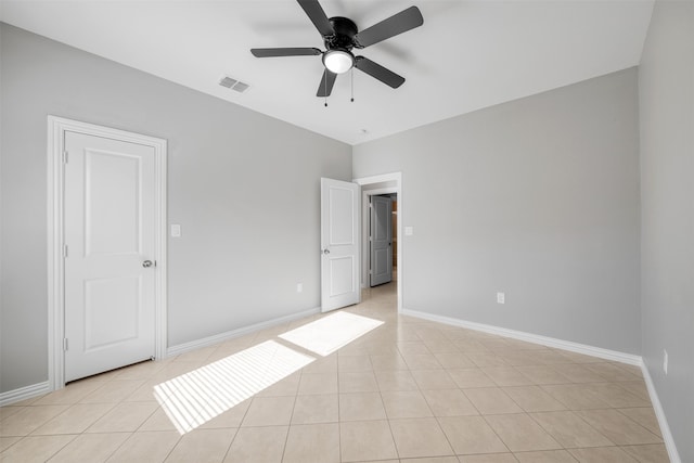 unfurnished bedroom with light tile patterned floors and ceiling fan