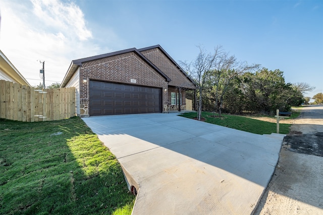 view of front of property featuring a garage and a front lawn