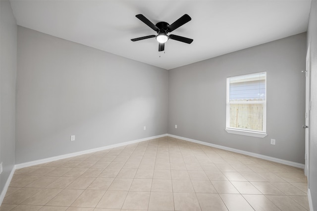 tiled spare room featuring ceiling fan