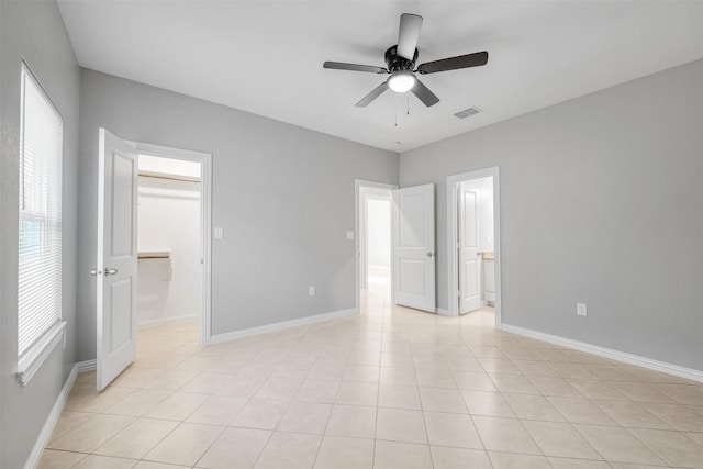 2803 Beechwood St, Granbury, TX 76048 - unfurnished bedroom with a walk in closet, baseboards, and ceiling fan