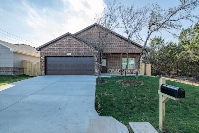 view of front of home with a front yard and a garage