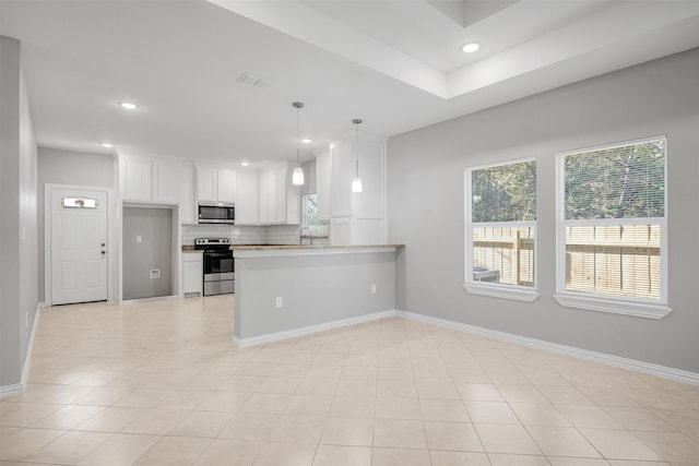 2803 Beechwood St, Granbury, TX 76048 - kitchen featuring appliances with stainless steel finishes, healthy amount of natural light, tasteful backsplash, white cabinets, and recessed lighting