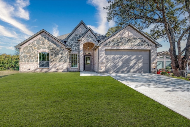 view of front of property with a front yard and a garage